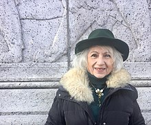 Portrait of Anna Frajlich in a black brimmed hat and a coat with a fur collar.