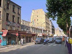 Paris, c'est aussi des quartiers populaires, principalement concentrés au nord et à l'est de la ville. Le boulevard de la Chapelle (18e arrondissement), se trouve dans un quartier dans lequel des populations immigrées, et notamment venant des anciennes colonies françaises, se sont retrouvées.