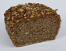A multigrain bread prepared with 70% sprouted rye, 30% spelt, and topped with various edible seeds Essene Bread 70pct Rye Sproud 30pct Spelt cut.JPG