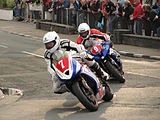 Newcomers Race 'A' John Simpson (7) 675 cc Triumph & Kamil Holan (9) 600 cc Yamaha – Lap 1 Parliament Square, Ramsey Saturday 25 August 2012