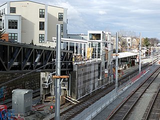 A light rail station under construction in an open cut