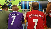 Fans of Real Madrid (left; Ronaldo's then current club) and Manchester United (right; Ronaldo's then former club as he joined United again in 2021) wearing Ronaldo's 7 shirt at the 2017 UEFA Super Cup SK 20170808 214655 (36289315022).jpg