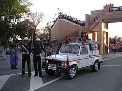 Two Corps of Military Police personnel stand beside their Maruti Gypsy.
