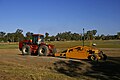 A pull scraper with a laser leveler, removing silt from the northern end