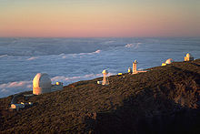 From left to right, the Herschel Telescope, the Dutch Open, the Carlsberg Meridian Telescope, the Swedish Solar Telescope, the Isaac Newton Telescope (second on the right) and the Jacobus Kapteyn Telescope (furthest on the right), in the Observatorio del Roque de los Muchachos, Isla de la Palma, Instituto de Astrofisica de Canarias. Ing telescopes sunset la palma july 2001.jpg