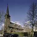 Overzicht van de zuidwestgevel met de kerktoren en met zicht op de er achtergelegen vergaderzaal en pastorie