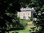 a country house surrounded by trees