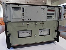 A caesium atomic clock from 1975 (upper unit) and battery backup (lower unit) President Pinera receives ESO's first atomic clock.jpg