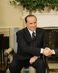 Silvio Berlusconi shaking hands with George W....
