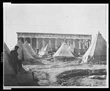 Temporary accommodation for the Greek refugees from Asia Minor Asia in tents in Thiseio. After the Asia Minor Catastrophe in 1922 thousands of Asia Minor Greek families settled in Athens and the population of the city doubled. Tent village in the shadows of the Temple of Theseus, Athens, where Greek refugees make thier (sic) homes LCCN2010650546.jpg