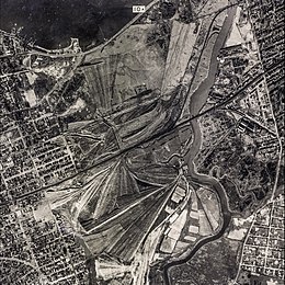 George Wilson and his wife Myrtle live in the "valley of ashes," a refuse dump (shown in the above photograph) historically located in New York City during the 1920s. Today, the area is Flushing Meadows–Corona Park.