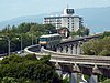 A train of the Osaka Monorail descends a grade near Senri-Chuo Station in 2011