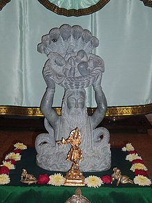 Stone statue of Krishna being carried across the river by Vasudeva Anakadundubhi