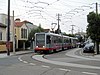 A train on 15th Avenue turning onto Ulloa Street, 2017