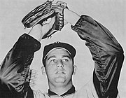 A man in a baseball uniform with the words "Braves", smiling for the camera.