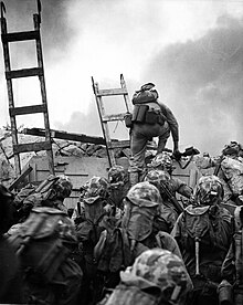 American Marines climbing a sea wall in Incheon during a decisive moment in the timeline of the Korean War Lopez scaling seawall.jpg