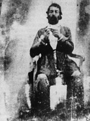 Prince Malek Qasem Mirza's daguerreotype self-portrait. He is seen with a watch in his hand to measure the exposure time. Malek Qasem Mirza.jpg