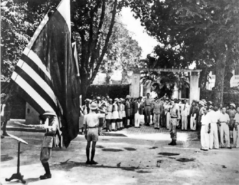 OSS Maj. Archimedes Patti and Vo Nguyen Giap saluted American flag, with a Viet Minh band playing the Star Spangled Banner, 1945 Aug 26, Sunday.