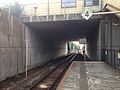 A view of the platform and track. The yellow walls above belong to the station building.