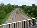 The railway line passing under the aqueduct.