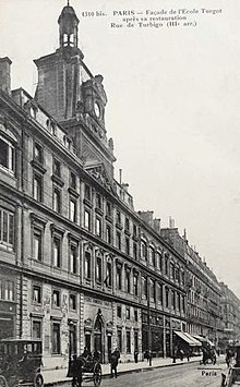 Cette photographie, imprimée sur une carte postale datant de 1904, représente l’ancien bâtiment du lycée Turgot. Le corps central de l’école était surmonté d’un fronton triangulaire et supportant le cadran d’une horloge. Un campanile dominait la toiture. La majeure partie du rez-de-chaussée était constituée de locaux loués à des commerçants qui établirent leurs boutiques.