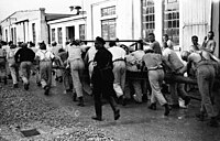 Prisoners in a Nazi concentration camp doing forced labour Bundesarchiv Bild 152-01-26, Dachau, Konzentrationslager.jpg