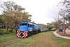 A train pulled by a EMD G22 locomotive decorated with corporate colors in August 2015