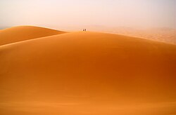 Two people atop one of the main dunes