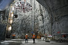 A tunnel boring machine cutter head being lowered underground for the construction of Sydney Metro Sydney Metro - Barangaroo - TBM Kathleen Cutterhead - Flickr - john cowper.jpg