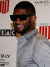 Usher wearing sunglasses smiling