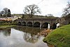 Stone bridge with six
                            arches over water.