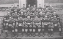 A team of football players seated