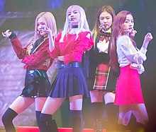 Blackpink performing "Playing with Fire" onstage