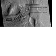 Material Flowing through a crater rim, as seen by HiRISE, under the HiWish program. Lateral moraines are labeled.