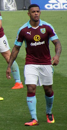 A coloured image of a focussed man staring in front of him