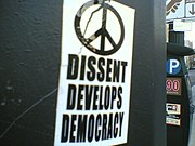 Sticker art arguing that dissent is necessary for democracy.