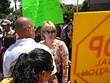 A woman with light blonde hair and sunglasses.