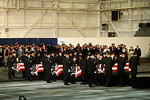 Caskets being carried in for a memorial service at Dover AFB on 16 December 1985 Memorial service for Arrow Air Flight 1285.jpg