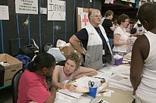 Residents of Louisiana, who had to flee their homes because of Hurricane Katrina, are inside the Houston Astrodome and being helped by the Red Cross and other agencies and associations. FEMA - 15322 - Photograph by Andrea Booher taken on 09-05-2005 in Texas.jpg