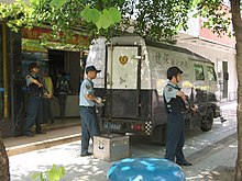 Armored car with a crew of security guards in Guangzhou, China Guangzhou-Cash-transport-0454.jpg