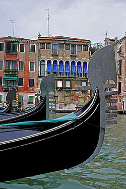 Several gondolas sail down the canals of Venice