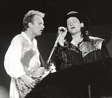 Sting and Bono performing a duet of the Police song, "Invisible Sun" at the Conspiracy of Hope concert on June 15, 1986, at Giants Stadium.