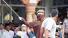 A convict receiving a caning sentence in Banda Aceh in 2014. Aceh caning 2014, VOA.jpg