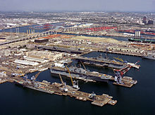 The Long Beach Naval Shipyard and the USS David R. Ray, Tarawa, and Essex in 1993. In the background is the original Gerald Desmond Bridge. Long Beach Naval Shipyard aerial view in October 1993.JPEG