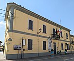 Municipio di Ronsecco, un edificio a due piani di colore giallo, con bandiere al balcone.