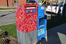 A Canada Post mailbox next to an empty Toronto Star vending box. Red post box here appears fuchsia! (27283651334).jpg