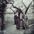Photograph of Susan Watkins and unidentified friends or relatives. Watkins is front right, seated on a ladder. ca. 1891-1900