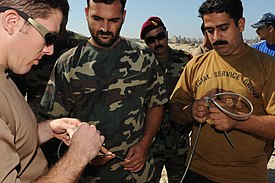 The Navy SSG SEAL Team working towards the underwater demolition charges with the US Navy SEALs during the military exercise in Alexandria in Egypt in 2009. US Navy 091012-N-0260R-076 Pakistani navy sailors listen as Explosive Ordnance Disposal Technician 1st Class Mark Peters.jpg