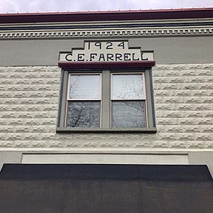 Window detail showing Farrell's name and the construction date