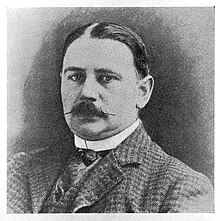 Black-and-white portrait photograph of a gentleman with moustache